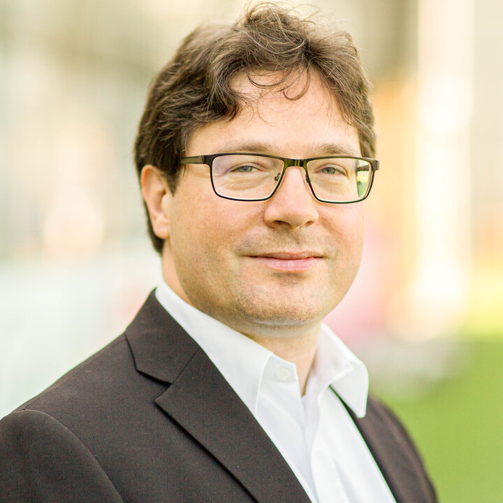 Philipp Fischinger in black suit smiling into camera