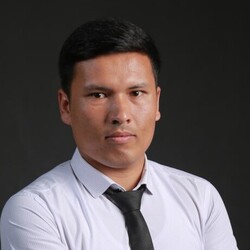 Karimov Okhunjon smiles into camera.