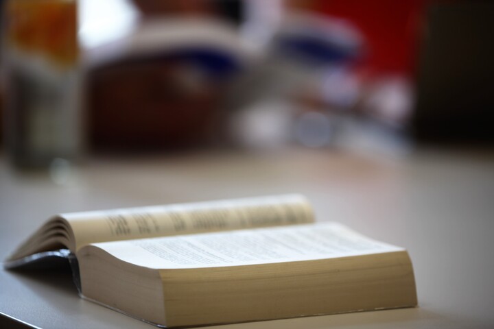 Aufgeschlagenes Buch liegt auf einem Tisch