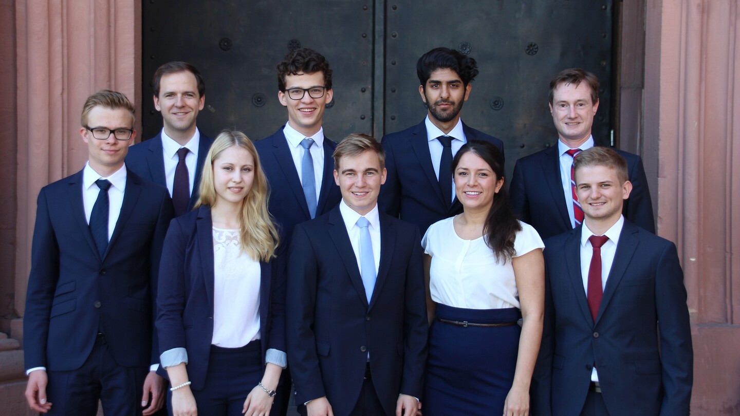 Gruppe von Studierender in formeller Kleidung vor dem Schloss
